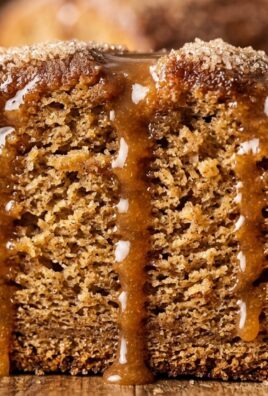 Ultra close-up of sliced apple cider donut loaf cake with cinnamon sugar crust
